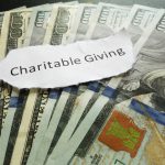 Charitable Giving paper message on assorted cash