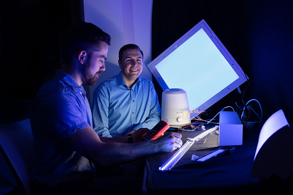 2 men in the dark at a desk